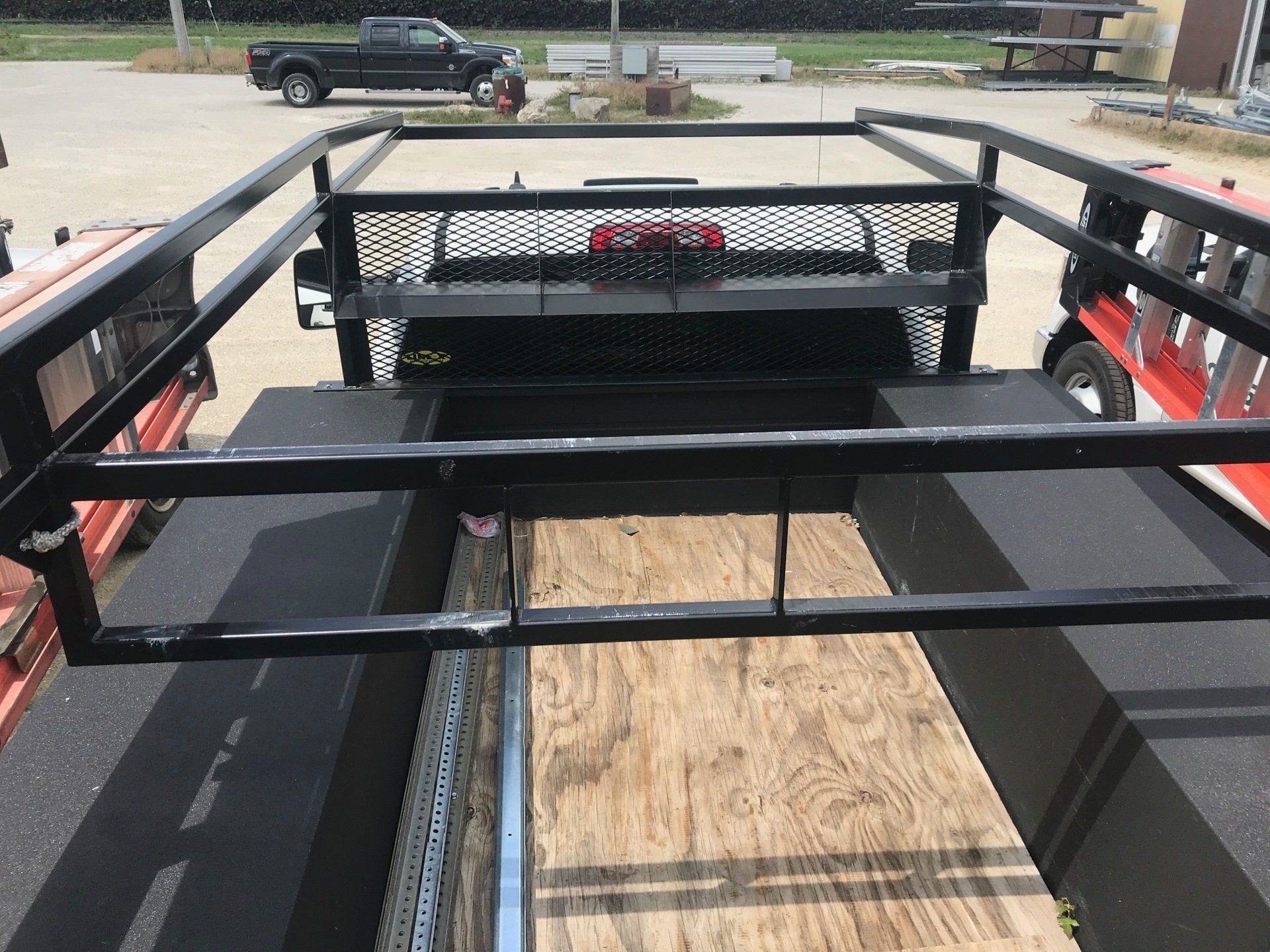 A truck with a ladder rack on the back of it