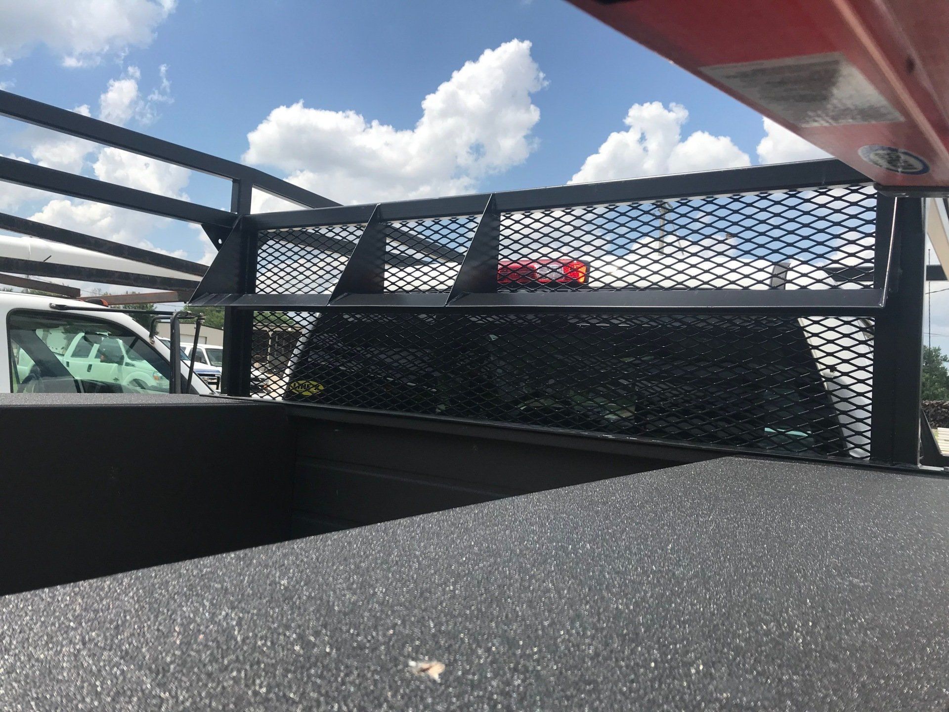 A truck bed with a ladder rack on top of it