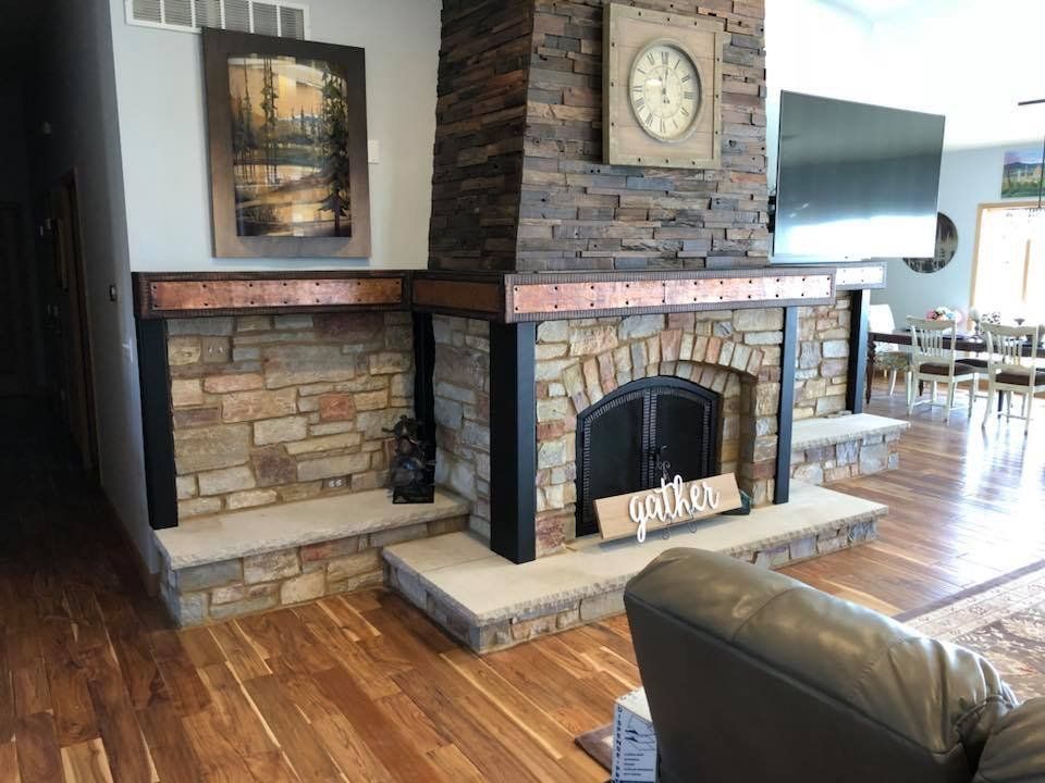 A living room with a fireplace and a clock on the wall.