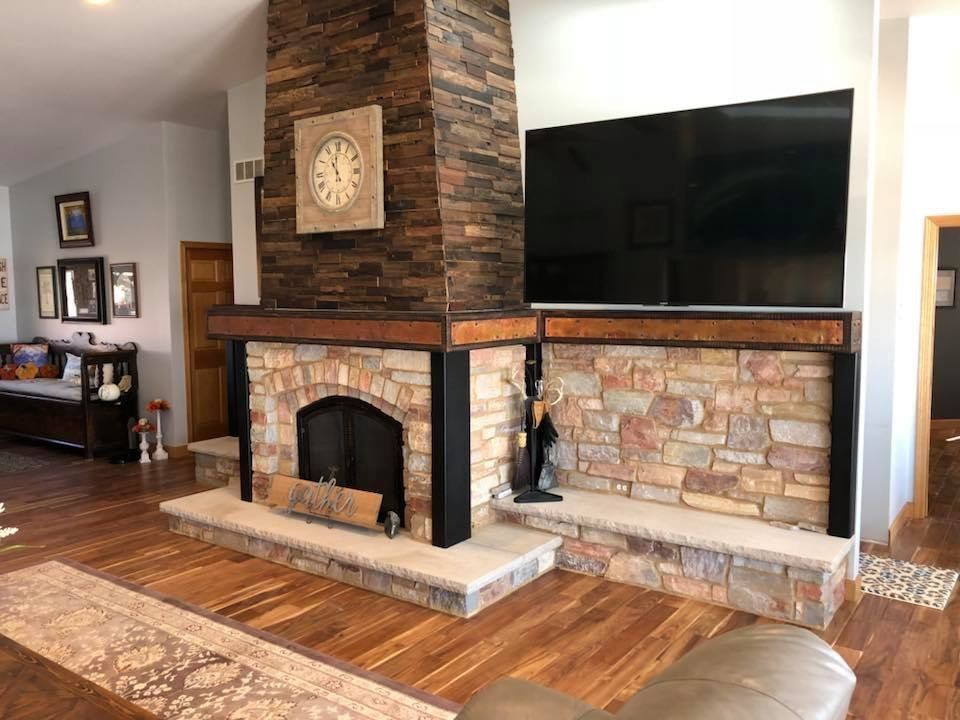 A living room with a fireplace and a flat screen tv.
