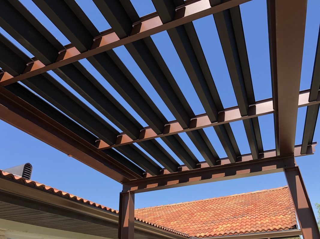 Looking up at a pergola with a blue sky in the background
