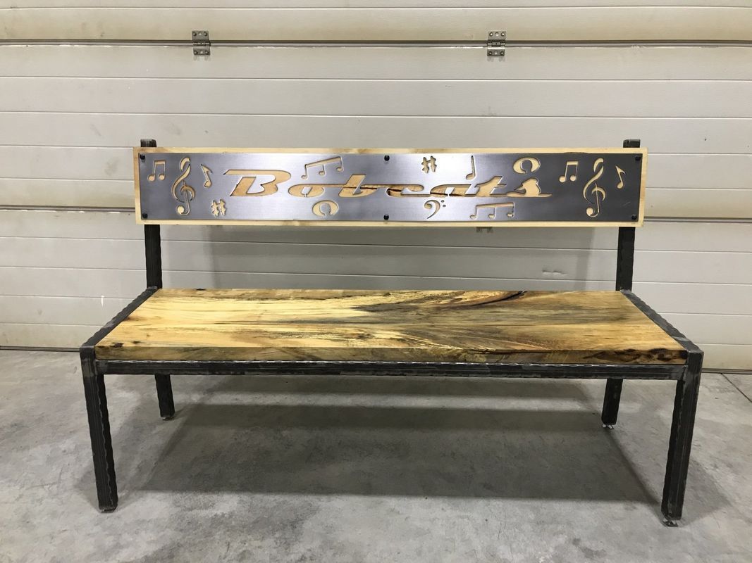 A wooden bench with a metal frame is sitting in front of a garage door.