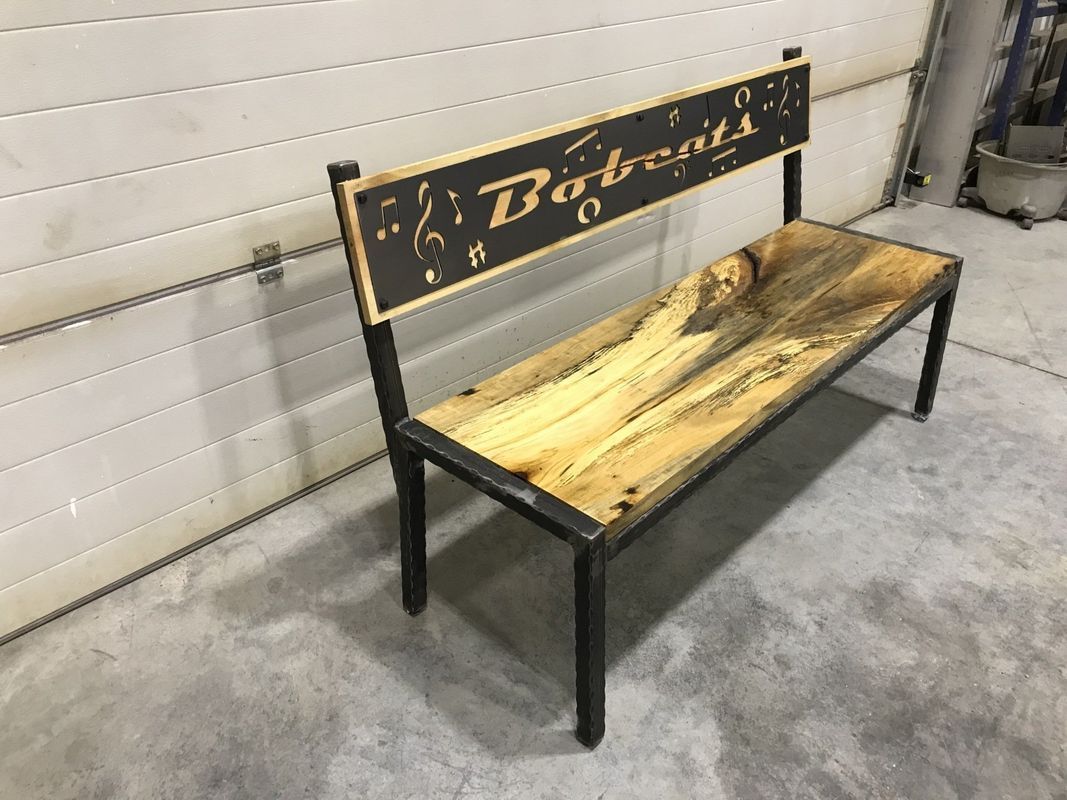 A wooden bench with a metal frame is sitting in front of a garage door.
