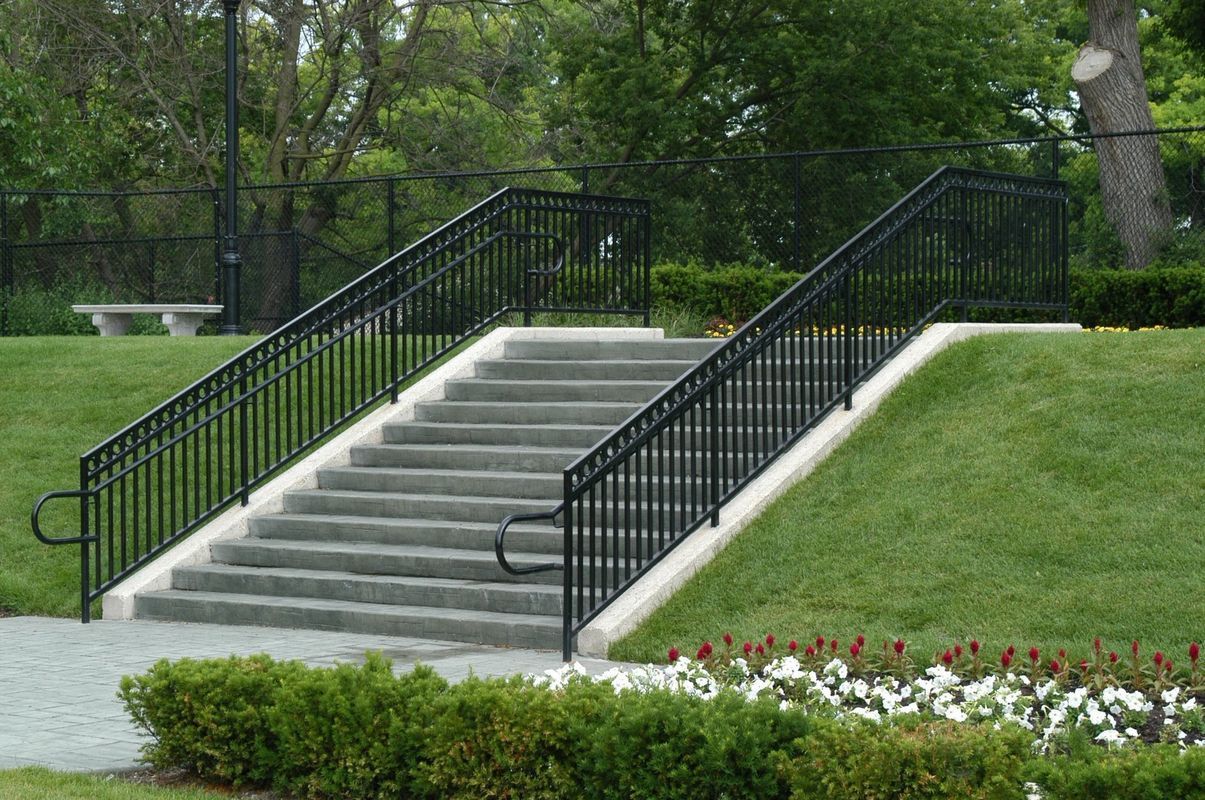 A set of stairs with a metal railing in a park