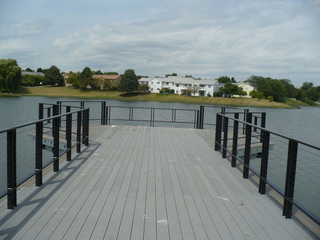 A dock overlooking a lake with a building in the background