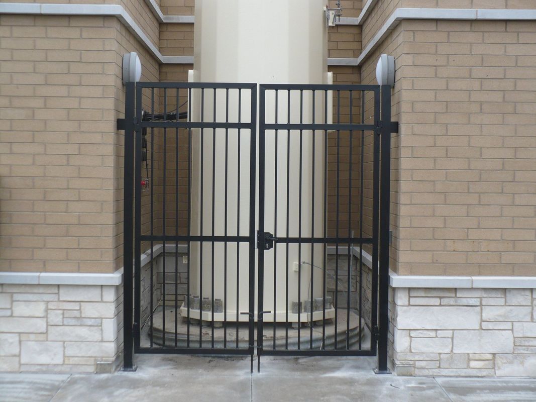 A brick building with a metal gate in front of it