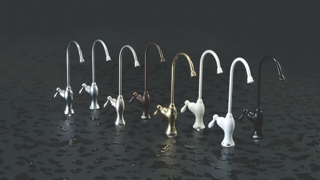 Row of curved bird-like sculptures in metallic and white tones on a reflective dark surface.