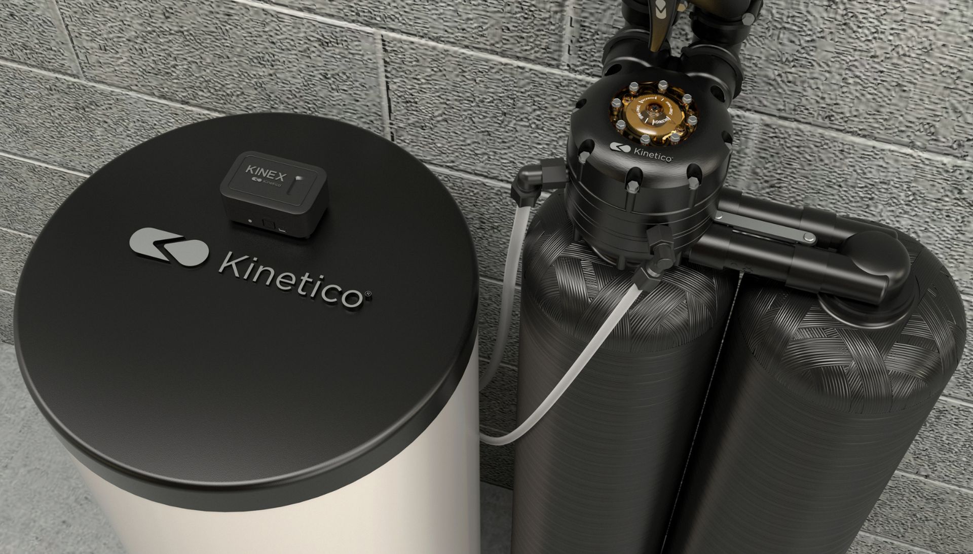 Kinetico water softener and filtration system beside a gray cinderblock wall, with black tanks and valve assembly.