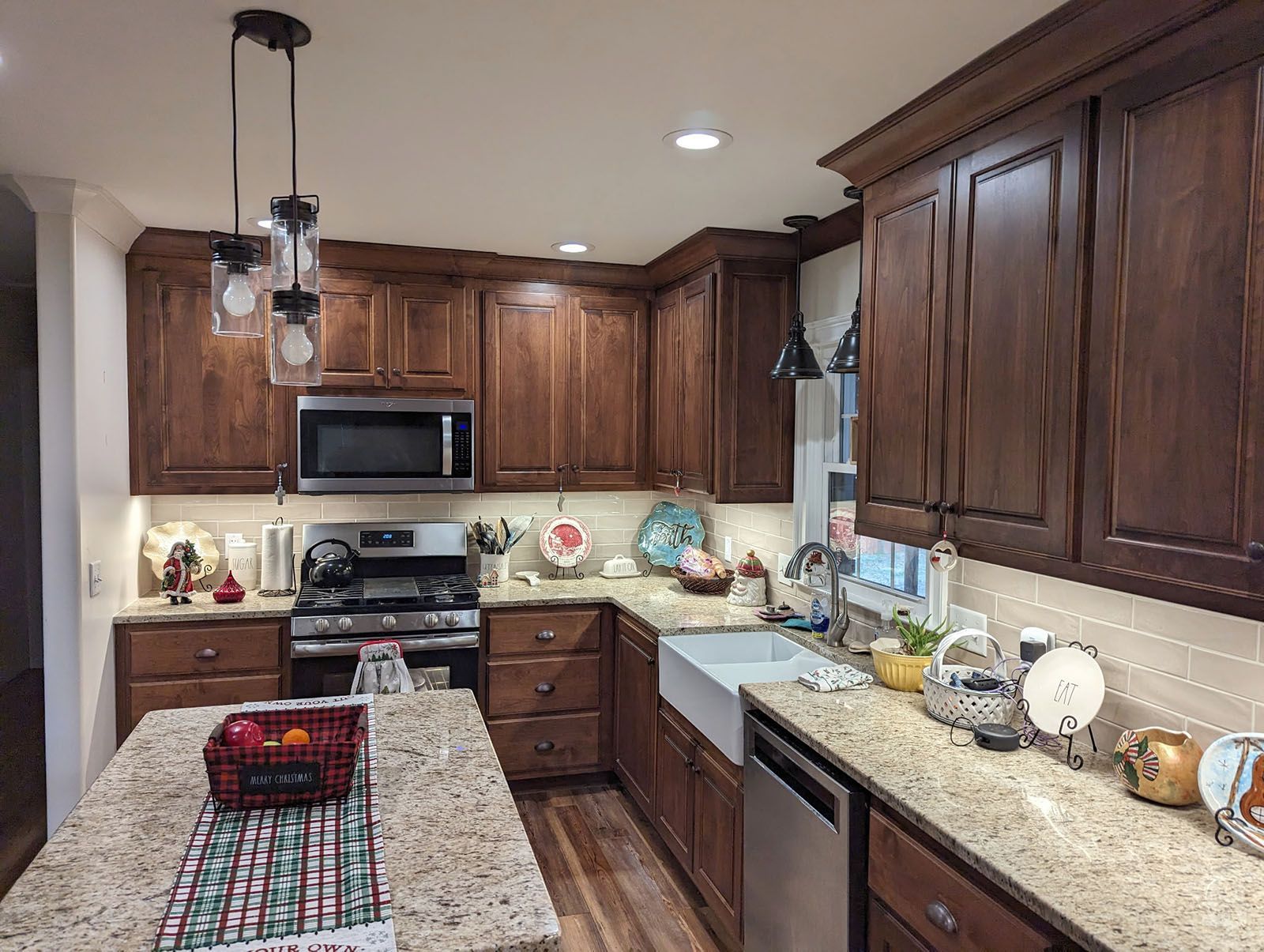 A kitchen with dark wood cabinets