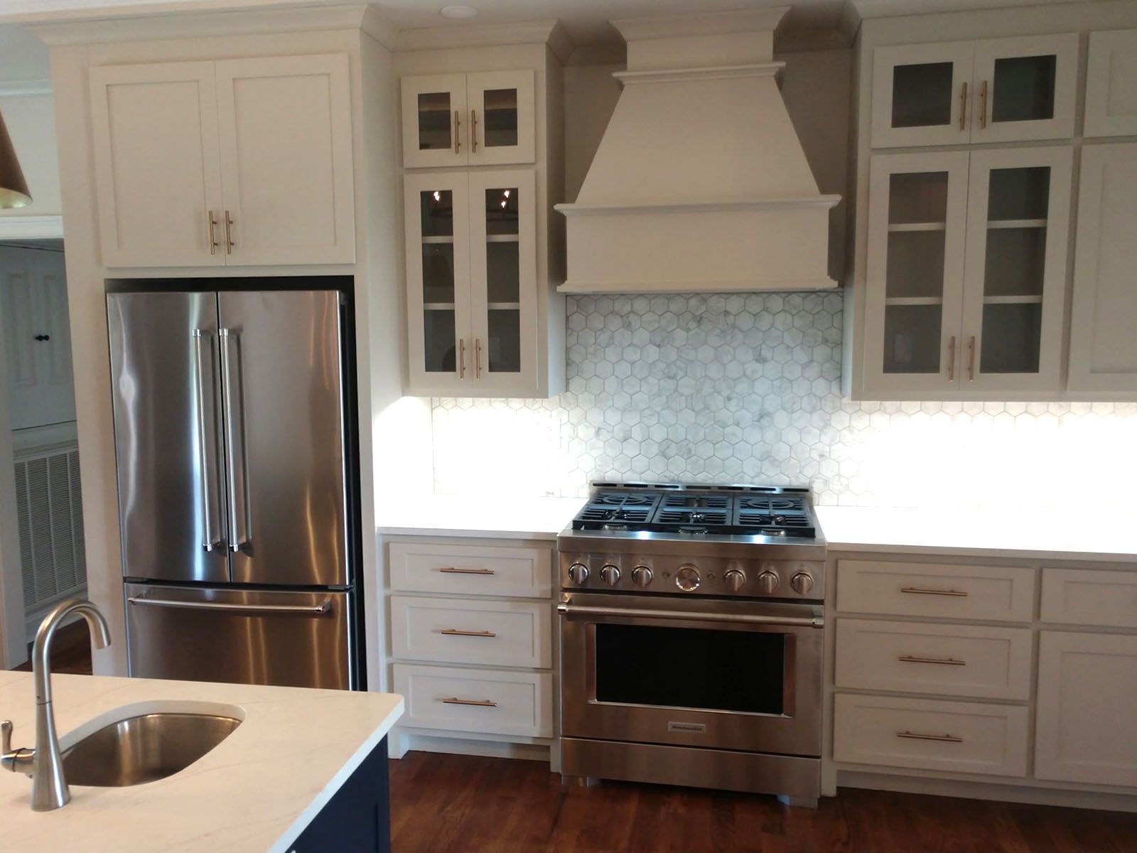 A kitchen with stainless steel appliances and white cabinets