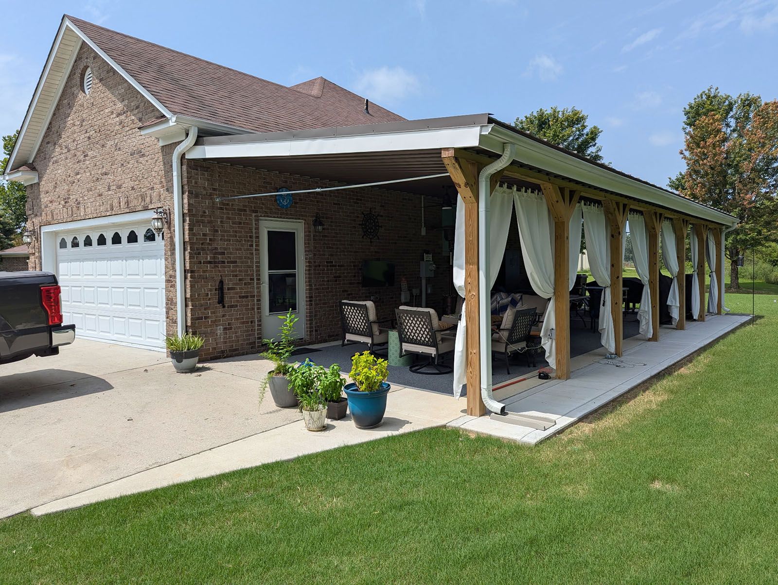 A covered patio with curtains