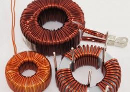 A group of copper coils are sitting on top of each other on a white surface.