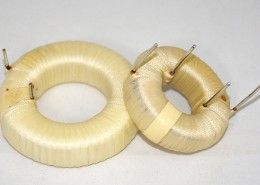 Two coil rings are sitting next to each other on a white surface.