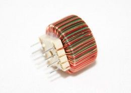 A close up of a coil on a white surface.