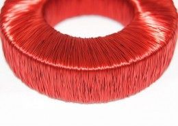 A close up of a red coil on a white background.