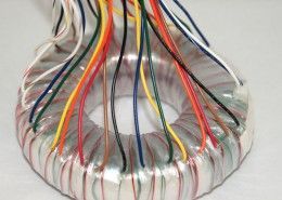 A close up of a transformer with a bunch of wires coming out of it.