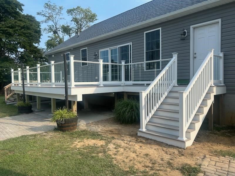 A house with a large deck and stairs leading up to it.