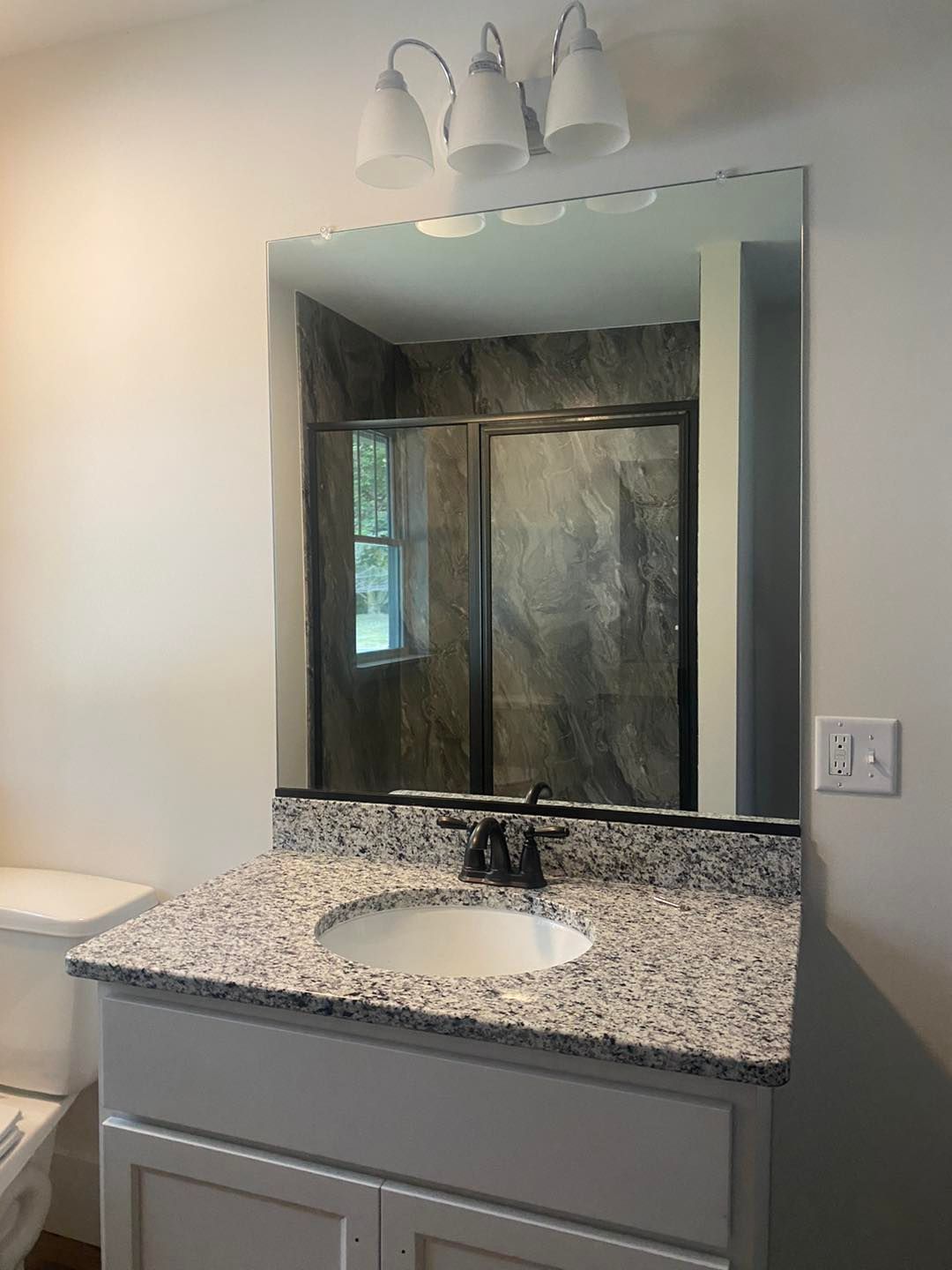A bathroom with a sink and a large mirror