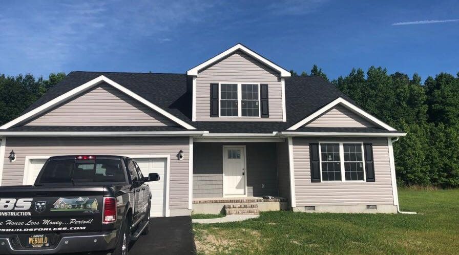 The back of a house with a porch and stairs