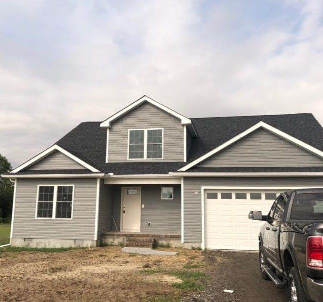 A house with a truck parked in front of it