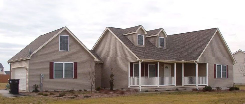 A large house with a porch and a garage