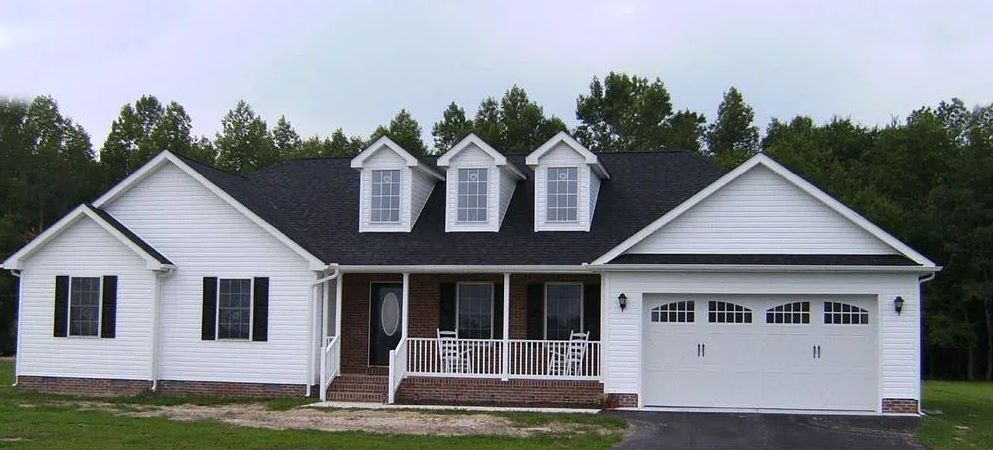 A white house with a black roof and a porch