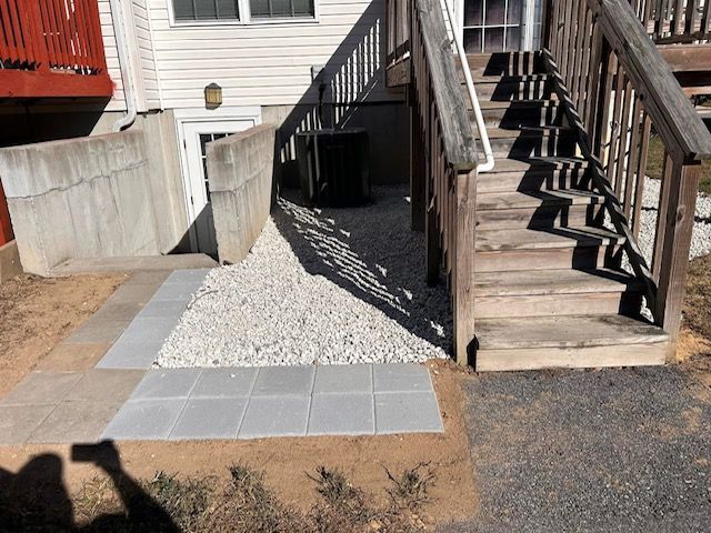 A wooden deck with stairs leading up to it
