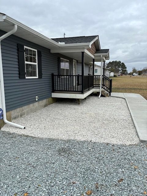 A house with a porch and a walkway leading to it