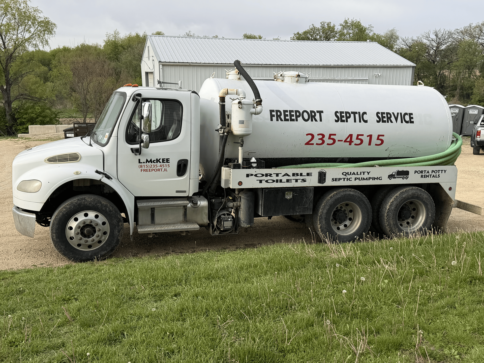White septic service truck parked on grass, labeled “Freeport Septic Service” with phone number 235-4515.