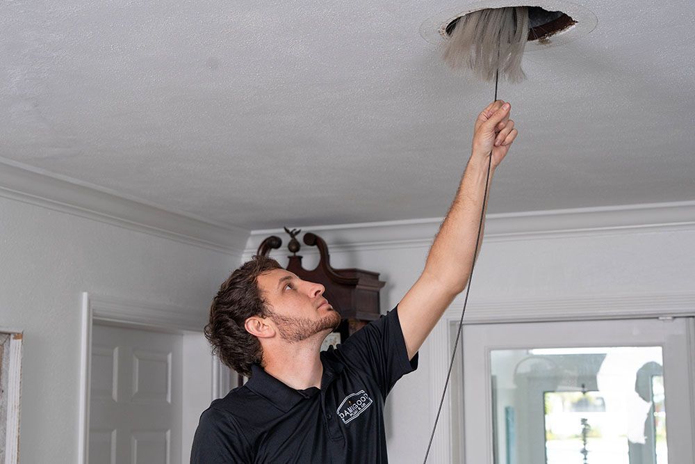 staff is cleaning the duct with a brush