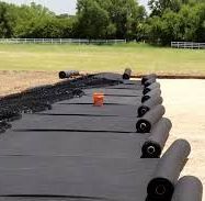 A piece of geotextile is lying on top of a pile of dirt.