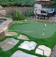 A white golf ball is sitting in the grass.