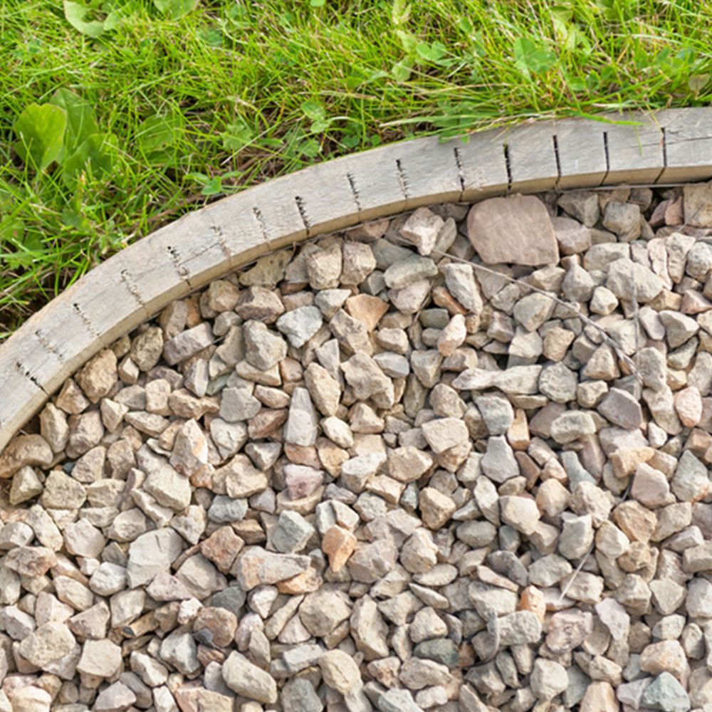 A pile of gravel next to a wooden edging.