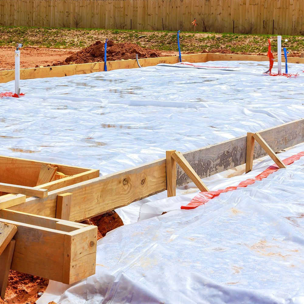 A construction site with a lot of wood and poly sheeting