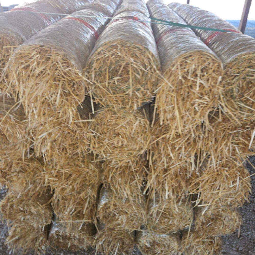A bunch of grass blankets stacked on top of each other