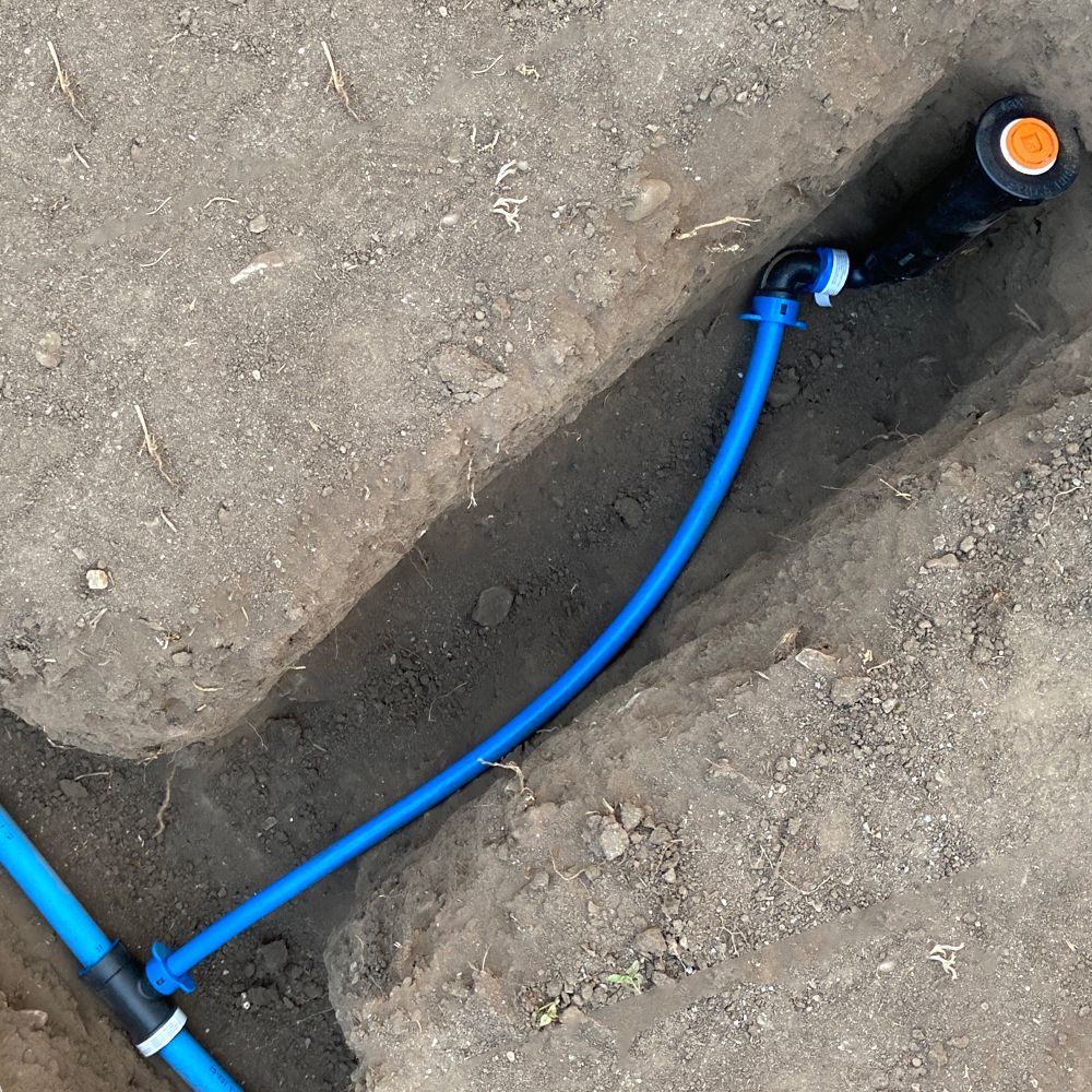 A blue funny pipe is connected to irrigation