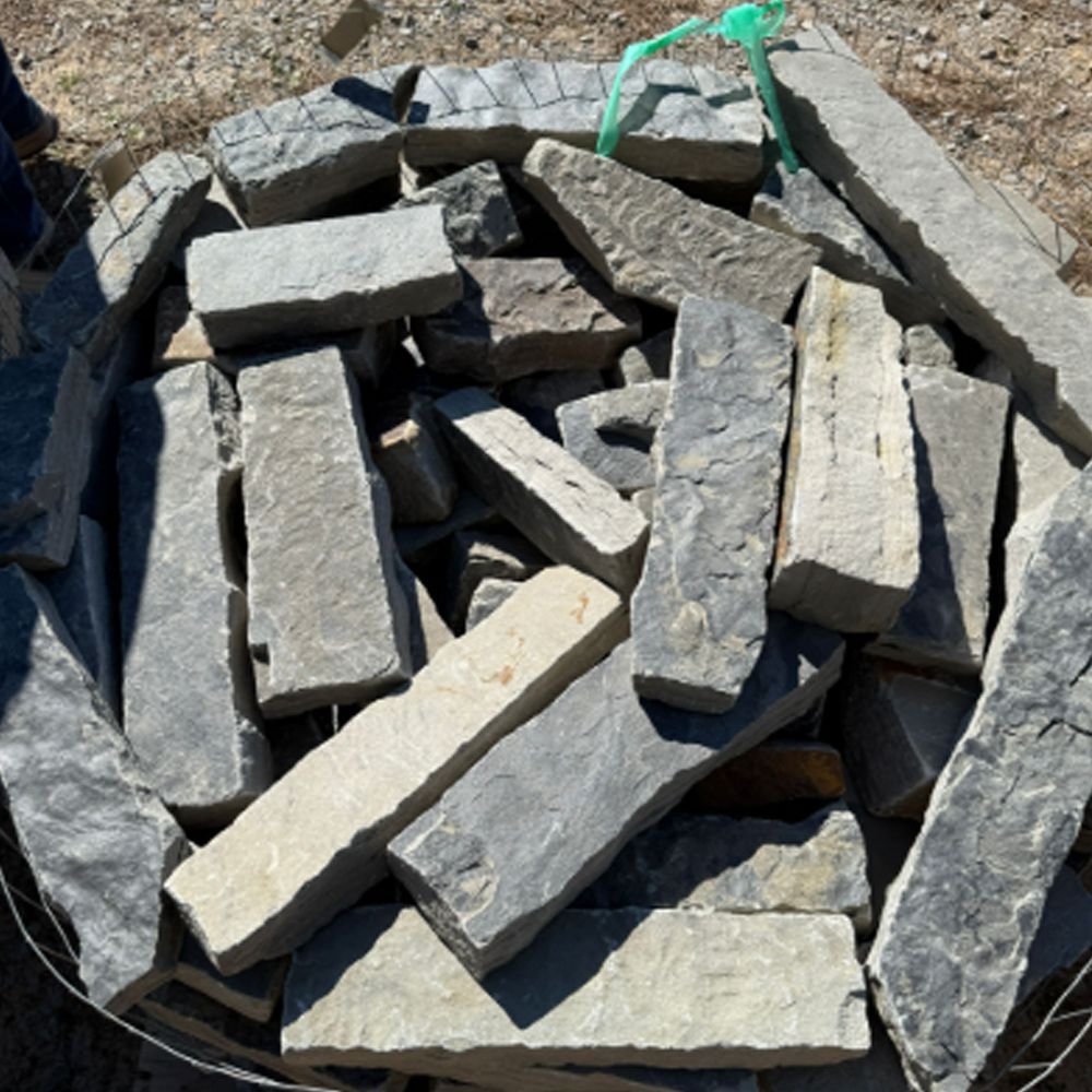 A pile of bricks with a green ribbon tied around them