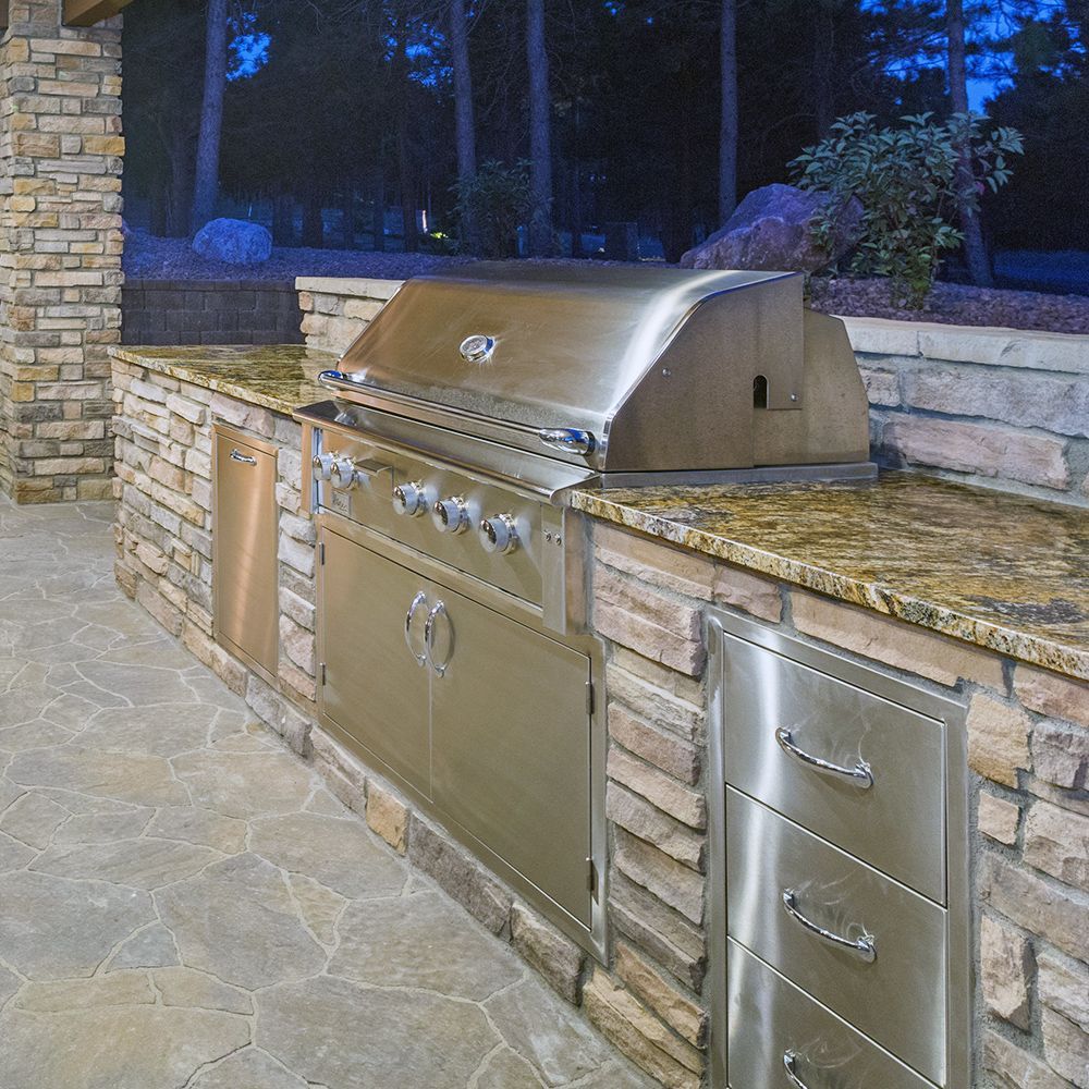 An outdoor kitchen with grill