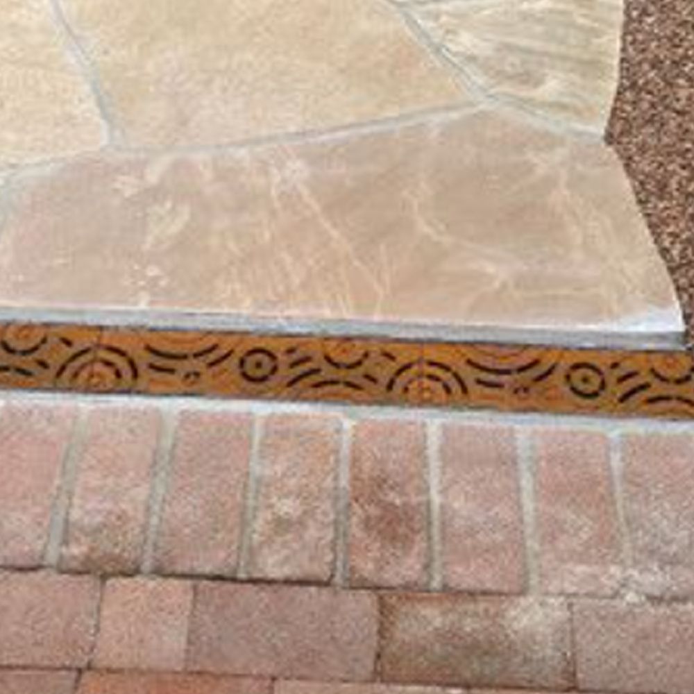 A close up of a door mat on a brick walkway.