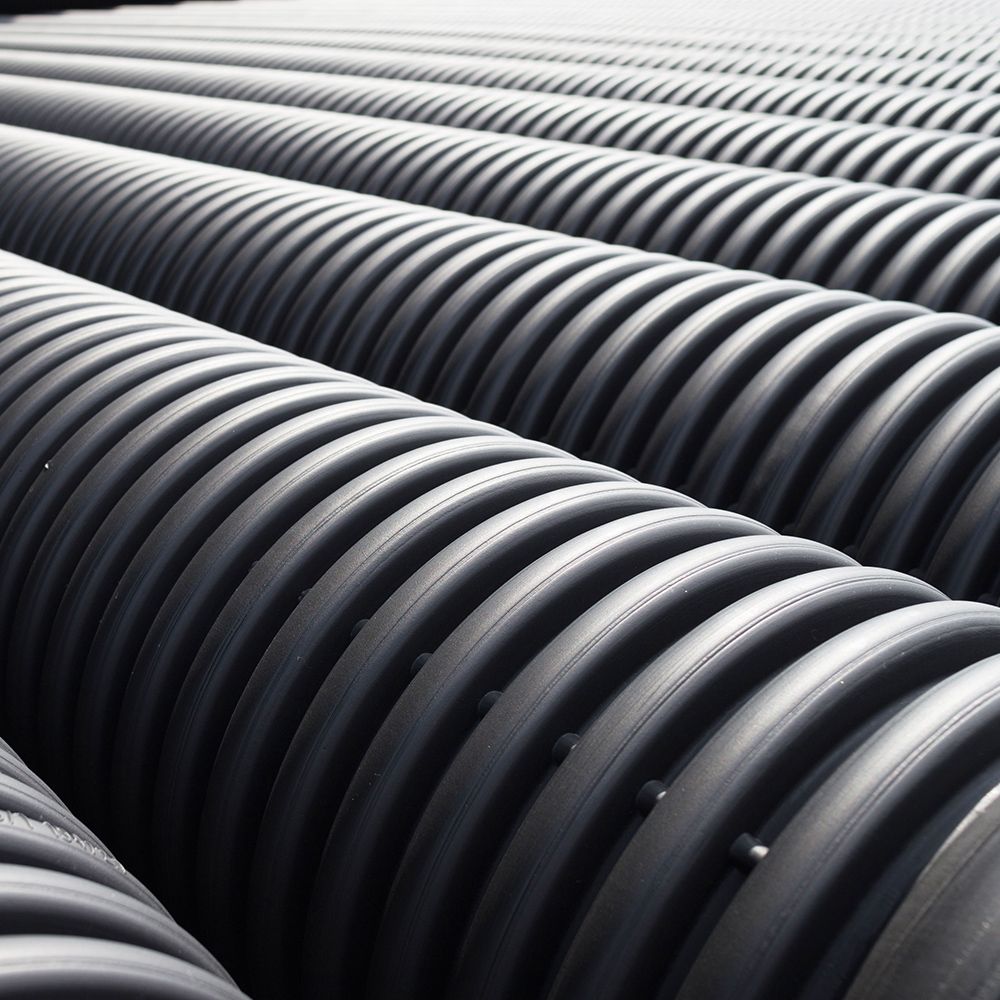 A bunch of black pipes are lined up in a row