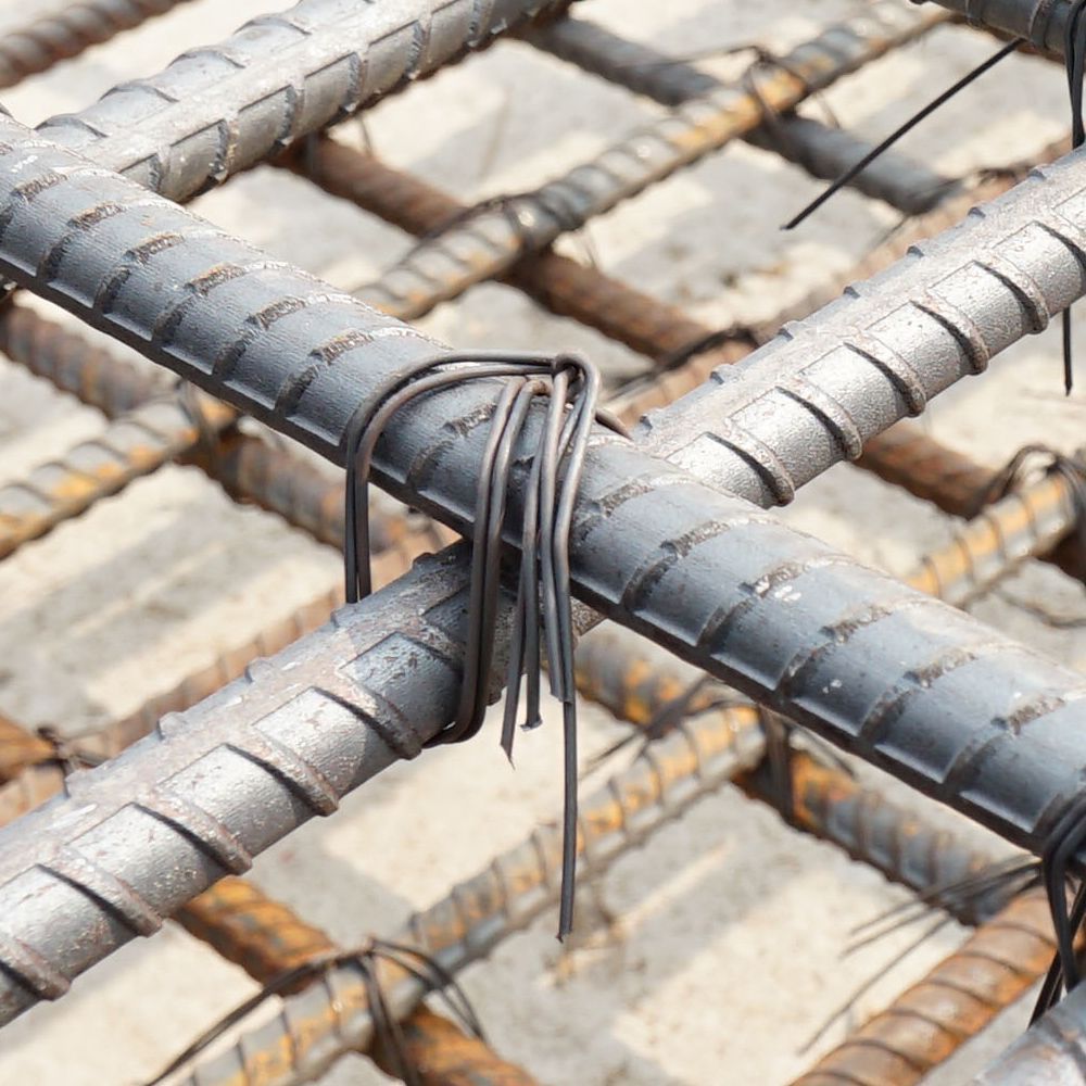 A close up of a bunch of steel bars with wire ties attached to them.