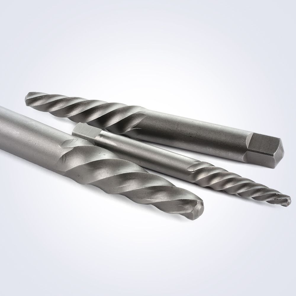 Three drill bits are sitting on top of each other on a white surface.