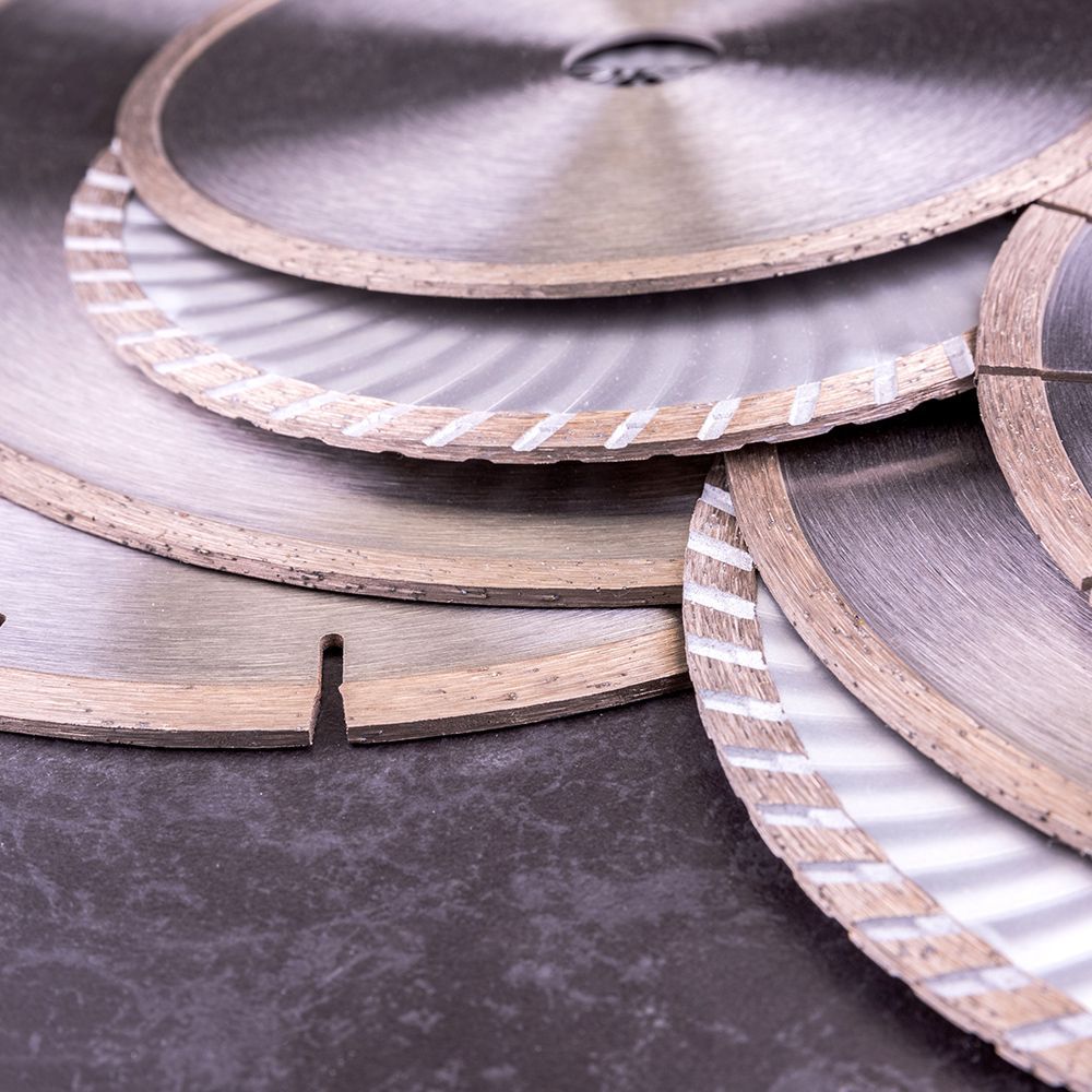 A group of diamond blades are stacked on top of each other on a table.