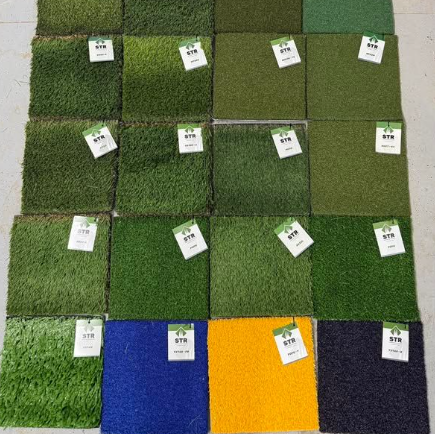 A bunch of pieces of artificial grass are sitting on a table.