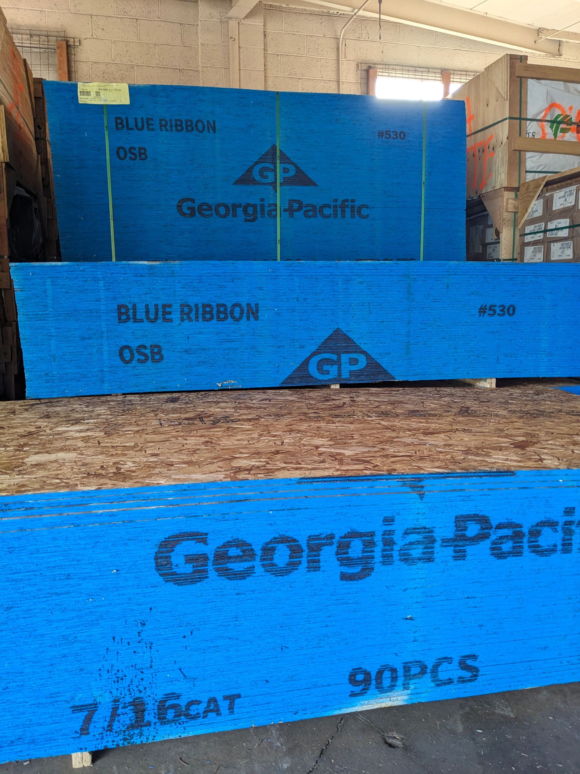 Stacks of blue Georgia-Pacific OSB (oriented strand board) lumber.