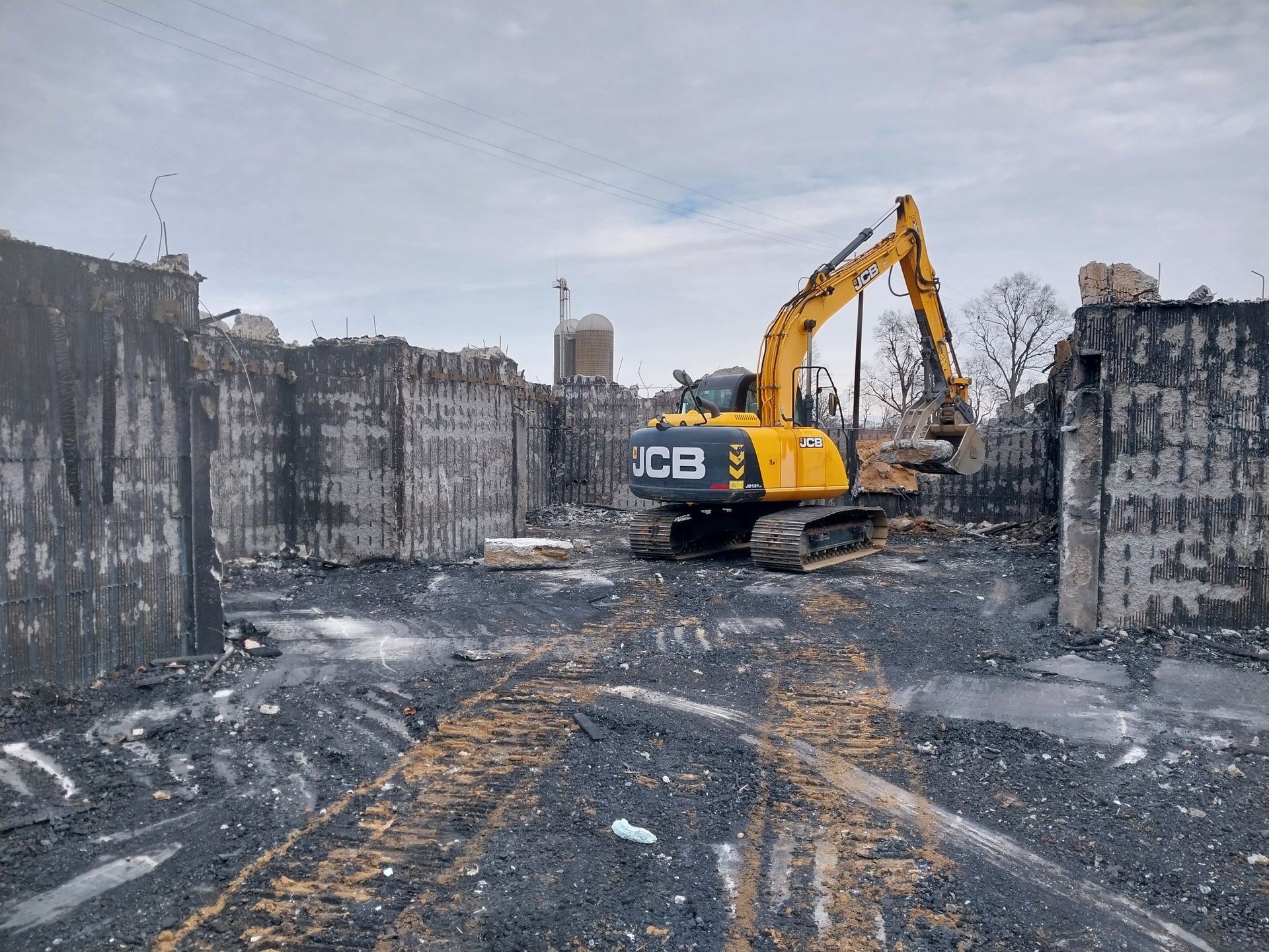 A yellow excavator is working on a construction site.