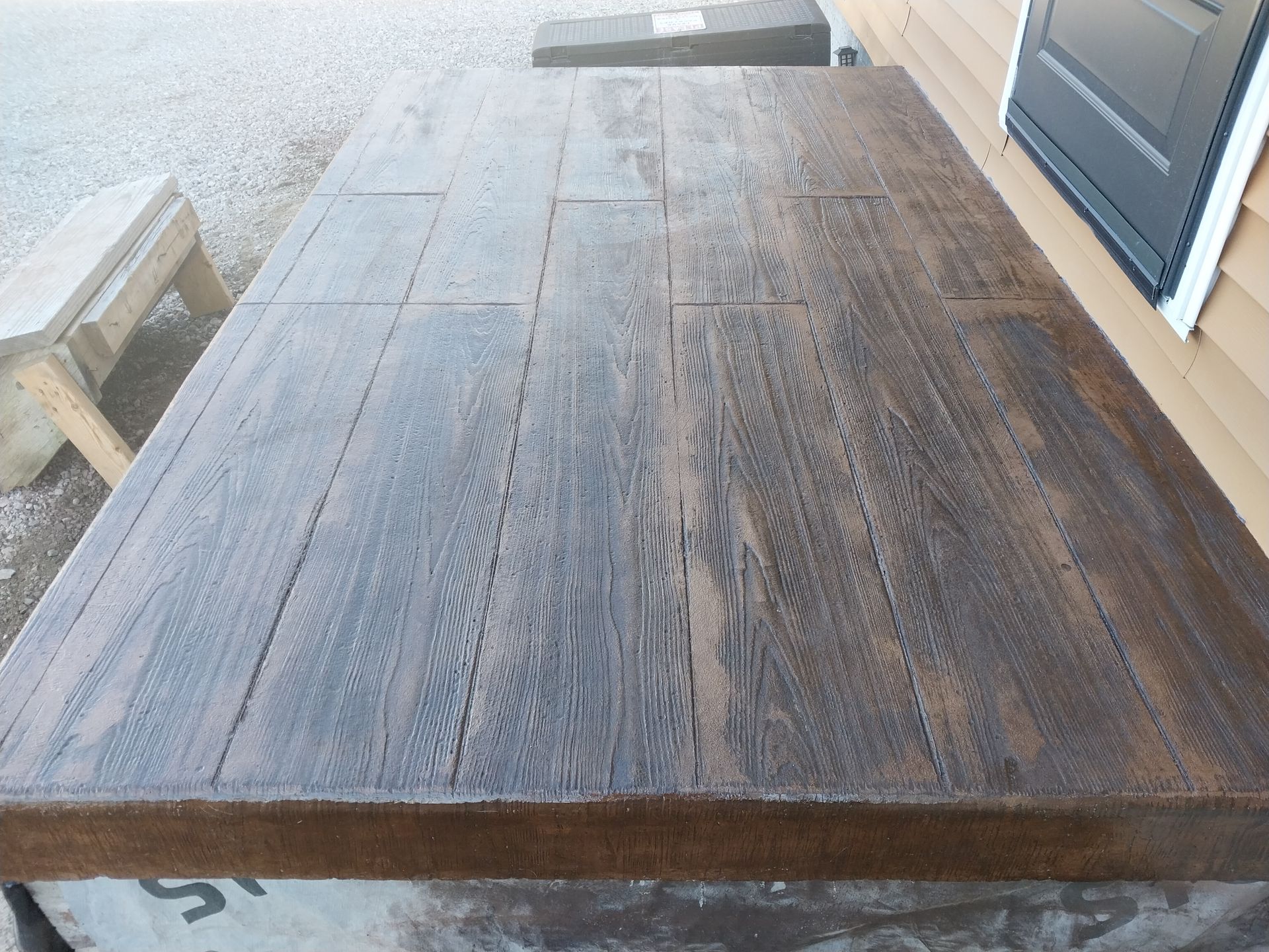 A wooden table with a black door in the background