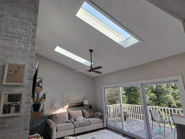A living room with a couch and a ceiling fan
