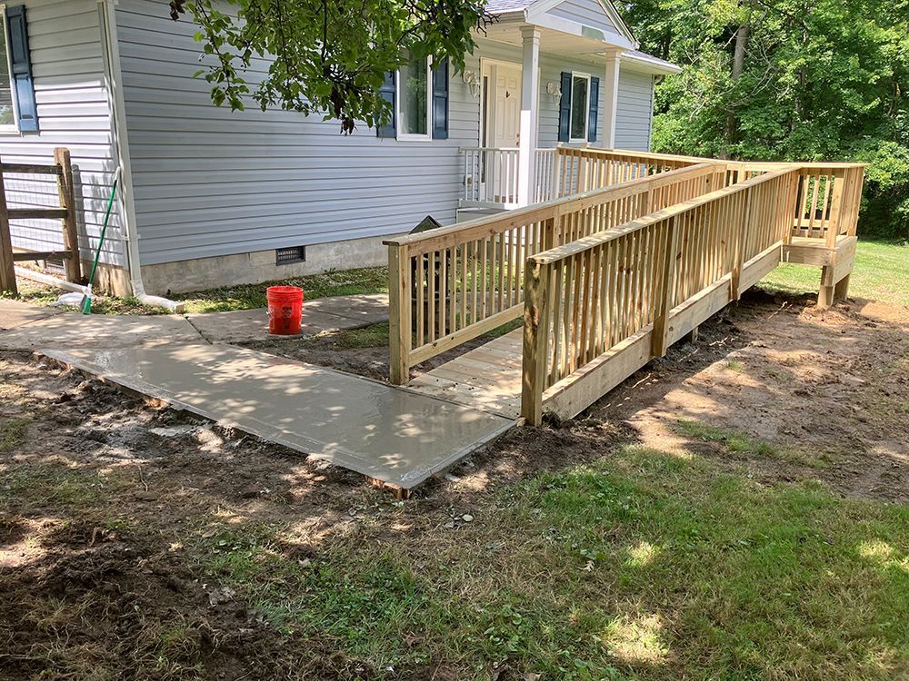 A wooden ramp is being built in front of a house.