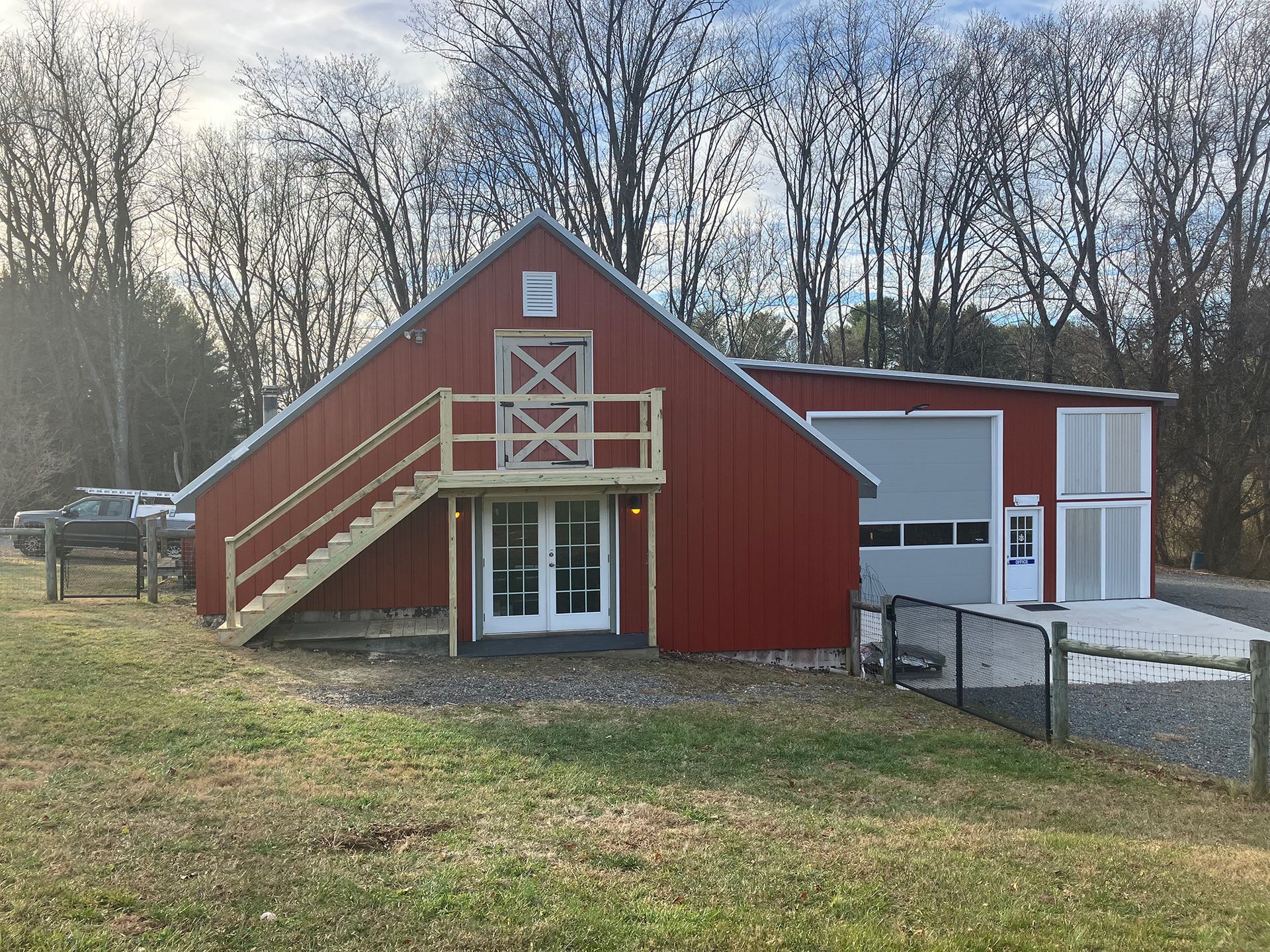 A large red barn with stairs leading up to it.